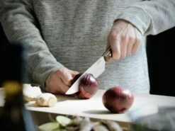 Fiskars Norr Chef's Knife -Kitchenware Shop Fiskars Kitchen Action Norr Cooks knife cutting onion 1016478